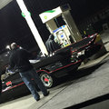 Saw bat man with bat Mobil at gas station