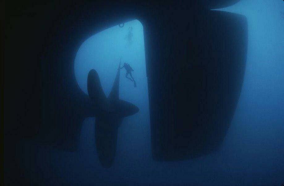 Divers at the main propeller of a cargo ship. - meme