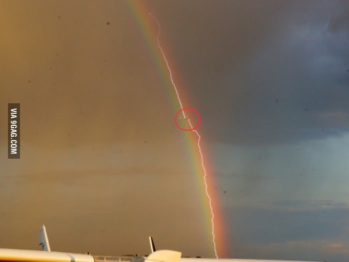 Picture of a lightning striking a plane in front of a rainbow - meme