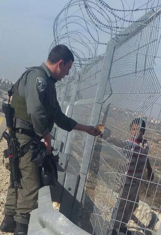 Israeli soldier giving food to gaza kid... And we still don't have hearts don't we? - meme