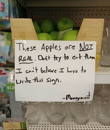 Apples are NOT real. Trust this weird sign - meme
