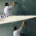 asian teacher drawing the world map