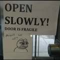 Open slowly, door is fragile